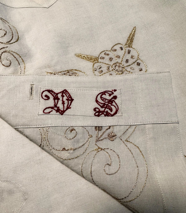 The shirt has embroidered initials "DS" on its front-facing bottom. These initials belonged to the previous owner of the tablecloth.